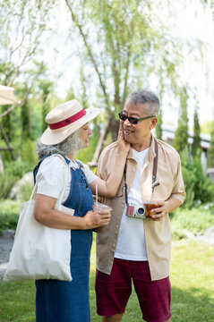 Asian Senior Couple Sharing a Romantic Moment Outdoors
