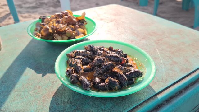 Traditional West Sumatran Minangkabau Culinary Dishes Langkitang and Pensi Freshwater Snails and Clams Served on Beach Table