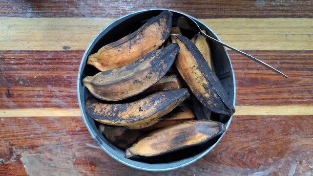 Traditional Indonesian Steamed or Boiled Plantain Bananas Pisang Rebus Served in Bowl on Wooden Table for Healthy Snack Concept