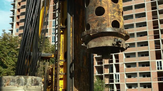 pile driver heavy machinery for concrete work at construction site, industrial piling machine for foundation building 4k