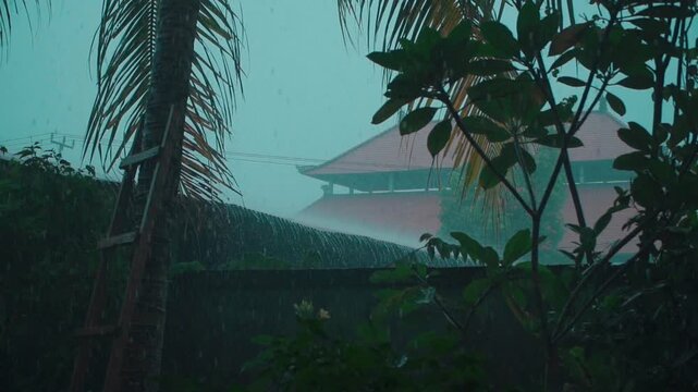 slow motion of tropical rain with temple in background, trees and palm forest in rainy weather, asian nature landscape 4k