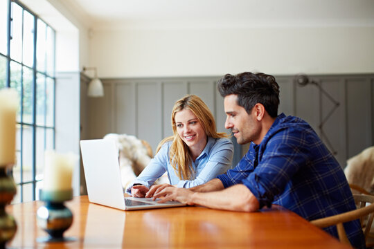 Smile, couple and relax in home with laptop, social media and browsing website for latest movies. Happy, people and reading in lounge with pc, internet search and streaming online for film watchlist