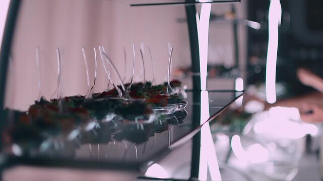 close up of hand taking elegant molecular cuisine dish at catering buffet, gourmet restaurant banquet food at event