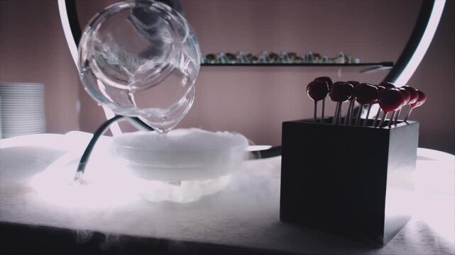 hand in glove preparing dry ice for molecular cuisine, close up of smoking bowl at catering banquet in event hall 4k