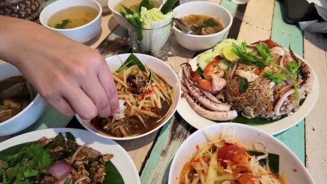 Person Eating Traditional Thai Street Food with Sticky Rice