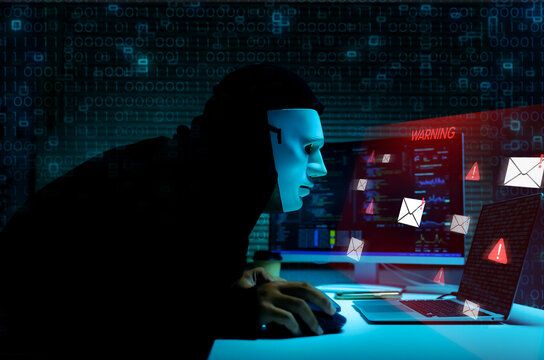 Cybercrime hacker mask using laptop for phishing attack and data theft for cybersecurity threat conceptual background