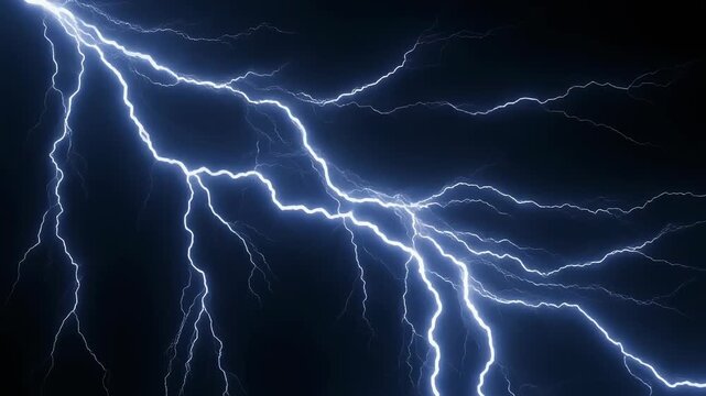 Intense electrical discharge and multiple lightning strikes illuminate the dark night sky during a severe thunderstorm creating a dramatic weather spectacle.