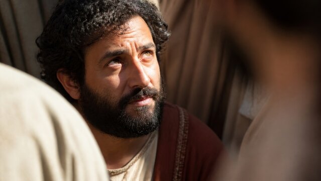 Biblical man gazing upward among a crowd, portraying Zacchaeus seeking to see Jesus in Jericho. Dramatic historical reenactment about faith, repentance, salvation, and spiritual transformation.