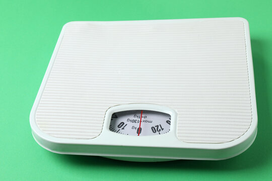 Floor scales and a measuring tape, top view.