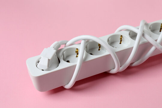 Electric extension cord on a colored background
