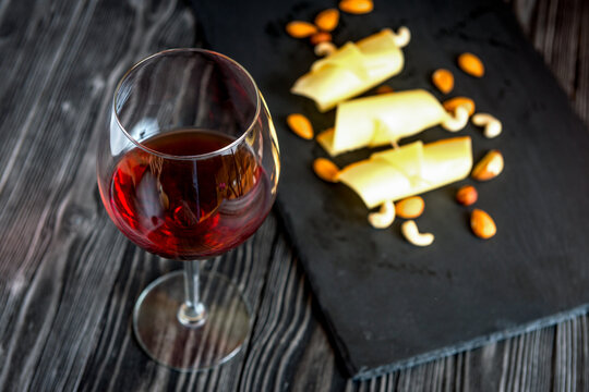 red wine with cheese on wooden background top view