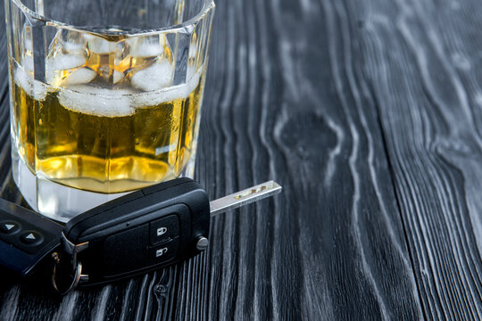concept of alcohol and driving on wooden background