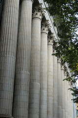 Colonnade of fluted columns with Corinthian capitals on a bank facade © Ekaterina