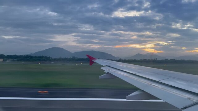Continuing the sequence the airplane lifts off from the runway and soars into the sky revealing a beautiful aerial landscape of the coastal city and distant green mountains beneath the evening clouds.