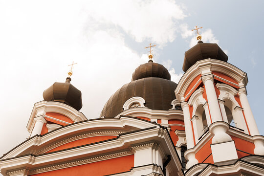 Roof of large historical church with crosses against open sky, religious architecture and faith concept