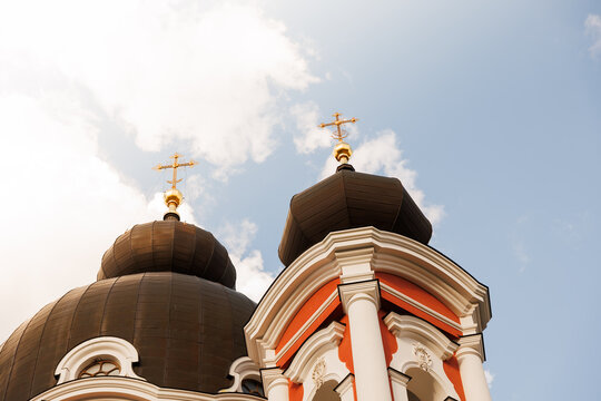 Roof of large historical church with crosses against open sky, religious architecture and faith concept