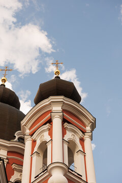 Roof of large historical church with crosses against open sky, religious architecture and faith concept