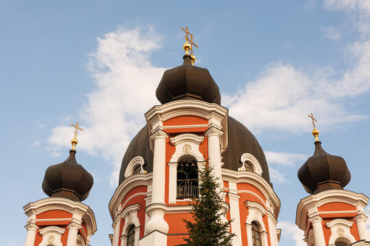 Roof of large historical church with crosses against open sky, religious architecture and faith concept