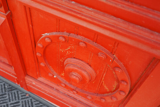 Decorative ornament on red wooden door, vintage entrance architecture concept