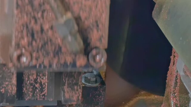 High-speed machinery intricately shapes copper tubes in a diligent manufacturing process for industrial air conditioning. This close-up reveals the artistry of production in stunning slow motion.