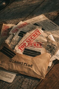 Vintage classified top secret documents in a weathered brown envelope
