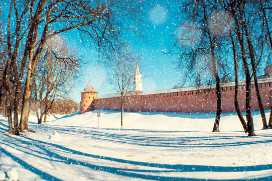 Veliky Novgorod Russia. Veliky Novgorod Kremlin fortress during snowfall in winter sunny day, wide angle panoramic scene. Selective focus at the towers