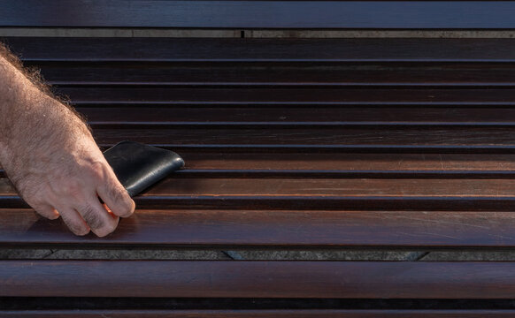 The lost wallet on the street, forgotten black leather object