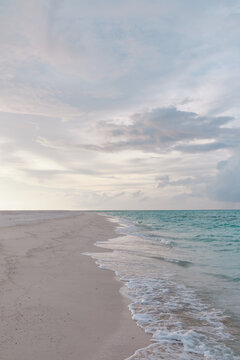 A tranquil beach shoreline with gentle waves in a beach