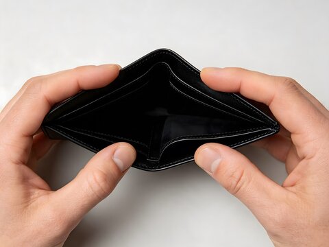 Hands holding an empty black leather wallet on a white background