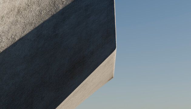 Close-up of a concrete building corner casting shadow under blue sky