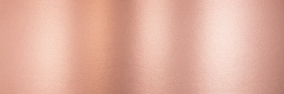 Rose gold metallic texture background, elegant copper foil surface with soft light reflections, luxury pink bronze metal sheet for premium branding, minimalist metallic backdrop for design