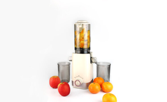 Modern juicer or juice extractor for juice or slow juice for extracting fresh fruit juice from apples and oranges featuring compact design clear containers and fresh ingredients for healthy nutrition