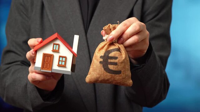 The euro is a money bag and a house in the hands of a business woman. Buying a house, investing in real estate. Property investment builds wealth. Housing market trends reflect economic stability grow