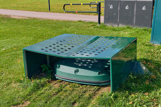 Smart home automation and garden maintenance robotic lawn mower at covered station in Brunnsparken Ronneby Sweden This innovative technology provides efficiency and convenience
