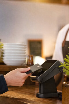 Customer making a secure card payment at a modern checkout terminal