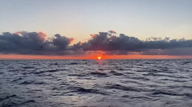  Sunset Over the Indian Ocean During Boat Trip near Gunner Quoin Island, Mauritius with Dramatic Clouds