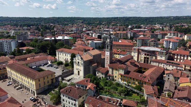 Aerial circling Church of the Nativity of the Virgin Mary. Cityscape of Arona, Italy.