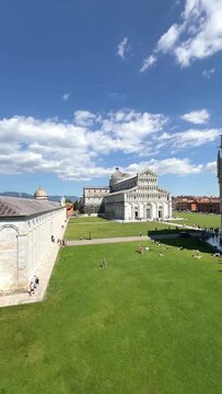 Piazza dei Miracoli in Pisa with the Baptistery of St. John, Cathedral and Leaning Tower under a blue sky, panoramic high angle view, Tuscany, Italy