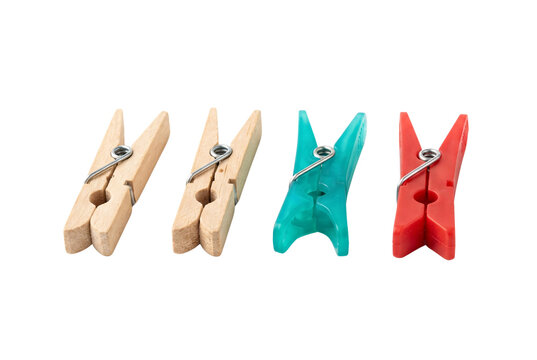Four clothes pegs made from wood, green plastic, and red plastic arranged in a neat horizontal row