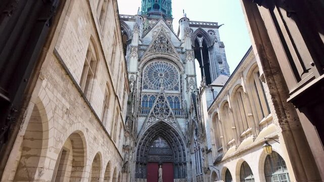 Lateral view of Saint-Maclou Church in Rouen, showcasing its intricate Gothic facade, ornate stonework, and soaring central tower.