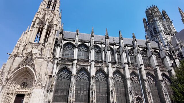 Historic Abbatiale Saint-Ouen captured on a sunny day in Rouen, revealing its elaborate Gothic facade and monumental proportions.