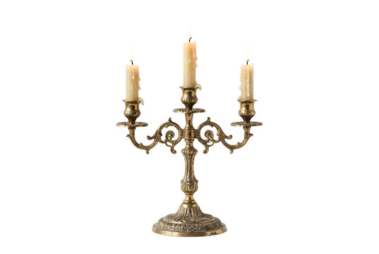 Ornate vintage brass candelabra holding three lit burning wax candles