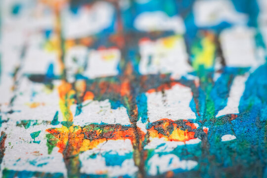 Extreme close up of colorful acrylic paint texture showing brush strokes. Selective focus.