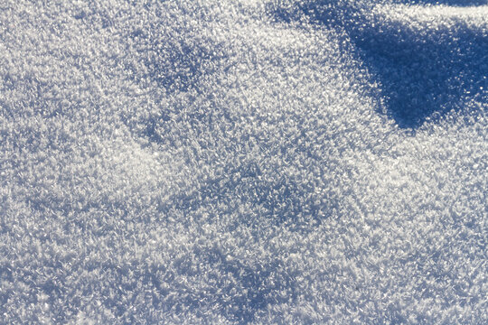 Natural winter backdrop featuring white snow texture. Winter white snow surface as background.