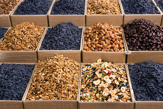 Dried fruits and nuts displayed in cardboard boxes at an oriental bazaar in Bukhara, Uzbekistan. Ideal for travel, food industry, or packaging design projects.