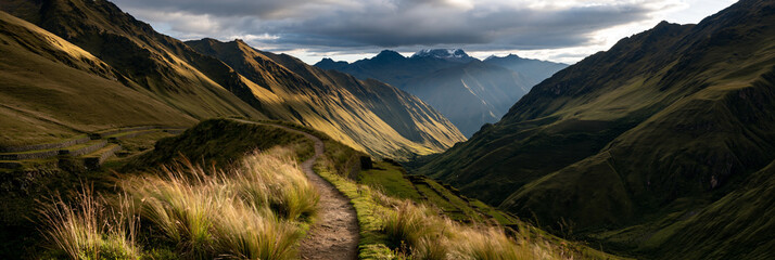 Naklejka premium impressive historic inca road winding through the andes, ancient stone path across dramatic mountain terrain, remote inca trail surrounded by terraces and snowcapped peaks