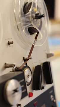Vintage reel-to-reel tape recorder playing music