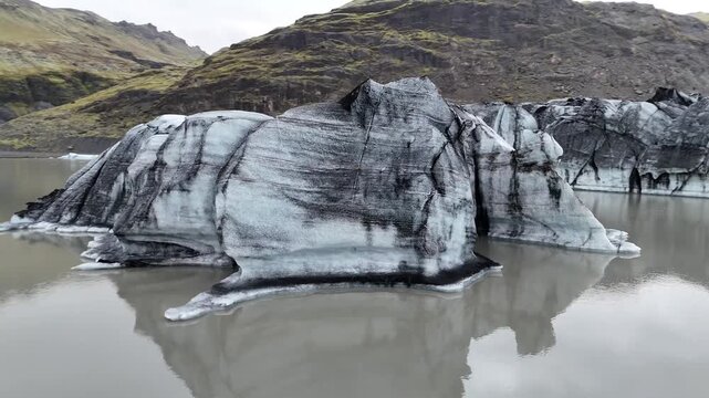Aerial Drone View of S&oacute;lheimaj&ouml;kull Glacier with Floating Icebergs in Glacial Lagoon Iceland 4K