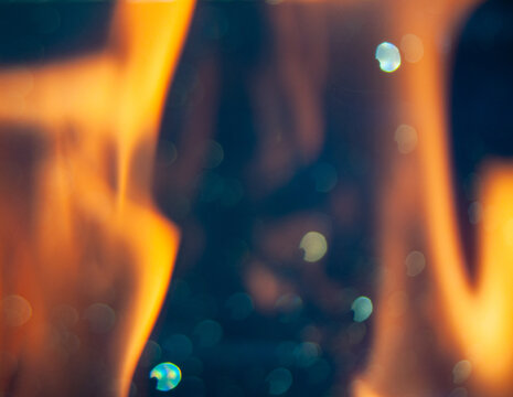 Bright flame burns with bright colors against a dark background
