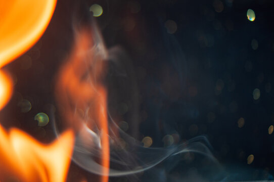 Bright flame burns with bright colors against a dark background